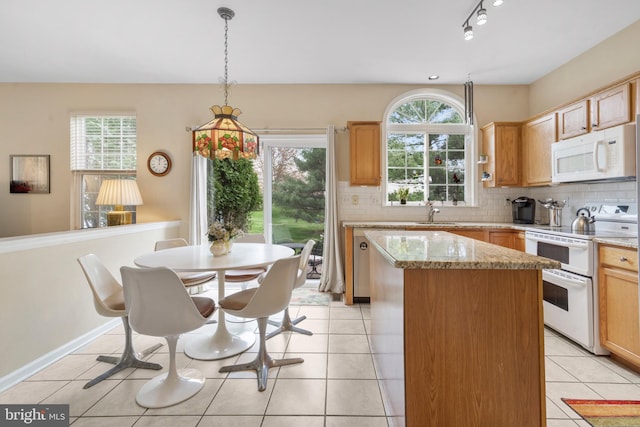822 Rhinehart Ln, Phoenixville, PA 19460 - kitchen featuring white appliances, a kitchen island, tasteful backsplash, light tile patterned floors, and light stone counters
