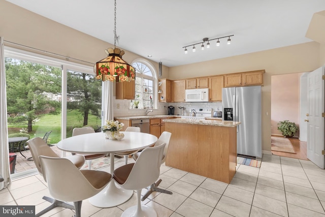 822 Rhinehart Ln, Phoenixville, PA 19460 - kitchen with stainless steel appliances, a kitchen island, a sink, decorative backsplash, and light tile patterned flooring
