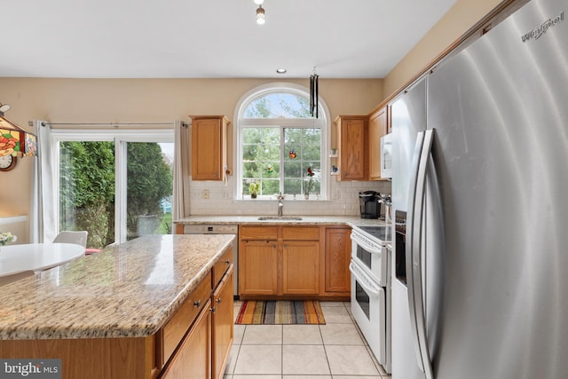 822 Rhinehart Ln, Phoenixville, PA 19460 - kitchen featuring white appliances, decorative backsplash, light tile patterned floors, a sink, and light stone counters
