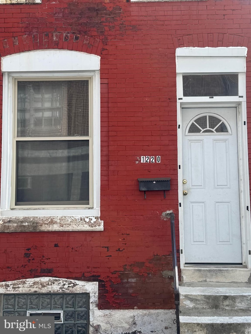 property entrance with brick siding