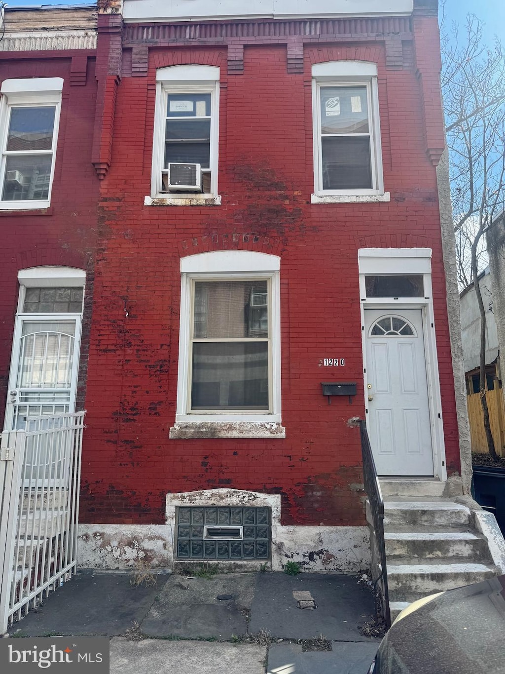multi unit property featuring brick siding, cooling unit, and entry steps