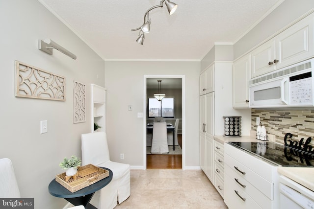 kitchen featuring white appliances, light countertops, white cabinetry, tasteful backsplash, and ornamental molding