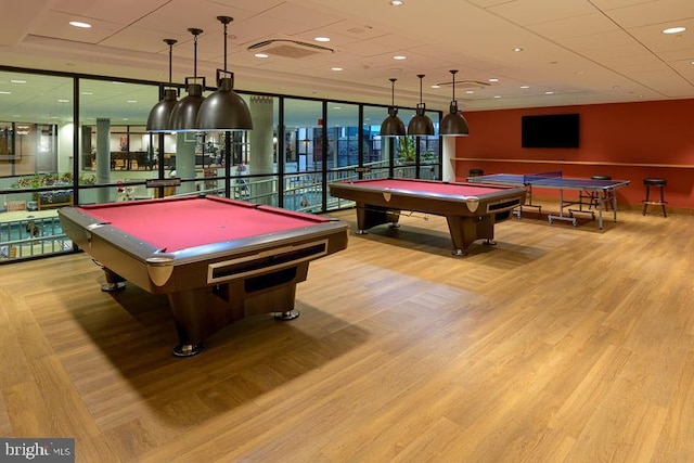 recreation room featuring billiards, floor to ceiling windows, and wood finished floors