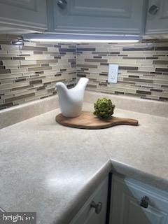 room details with light countertops and decorative backsplash