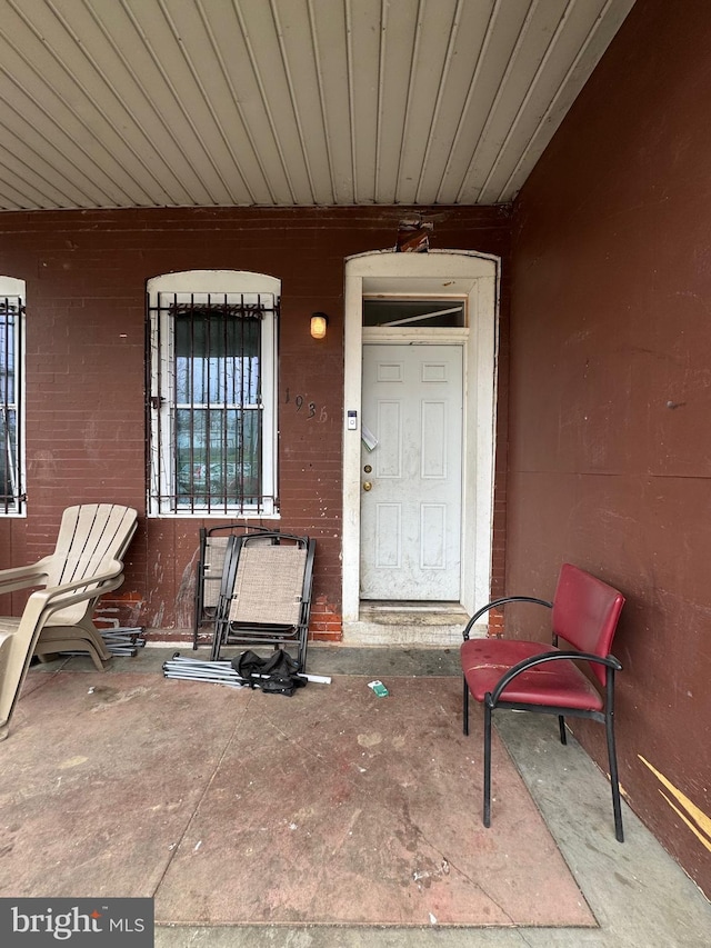 view of exterior entry with covered porch