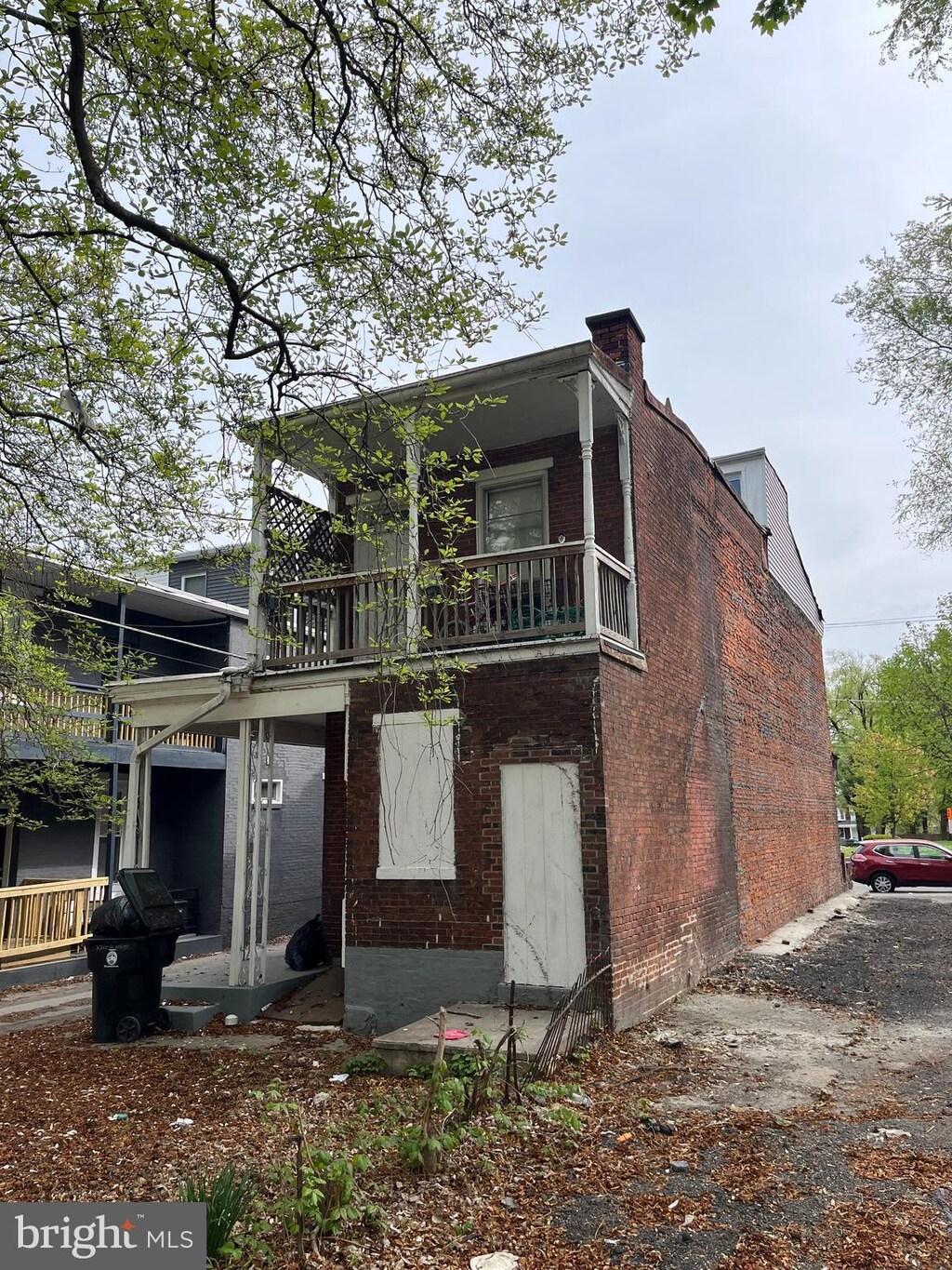 2628 N 6th St, Harrisburg, PA 17110 - back of house with a chimney, a balcony, and brick siding