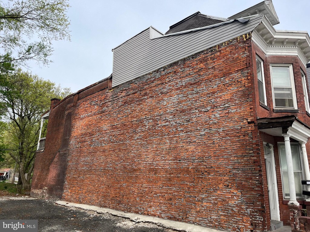 2628 N 6th St, Harrisburg, PA 17110 - view of home's exterior featuring a chimney and brick siding