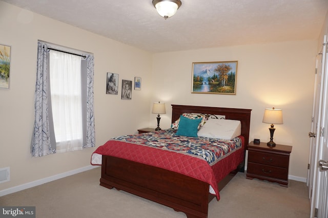 bedroom featuring visible vents, baseboards, and carpet floors