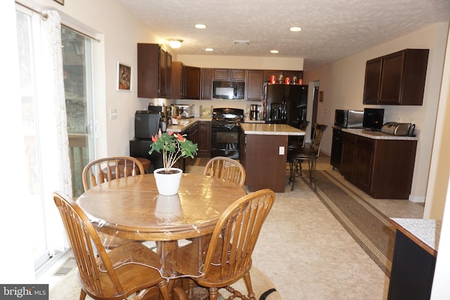 dining space with visible vents, recessed lighting, and a textured ceiling