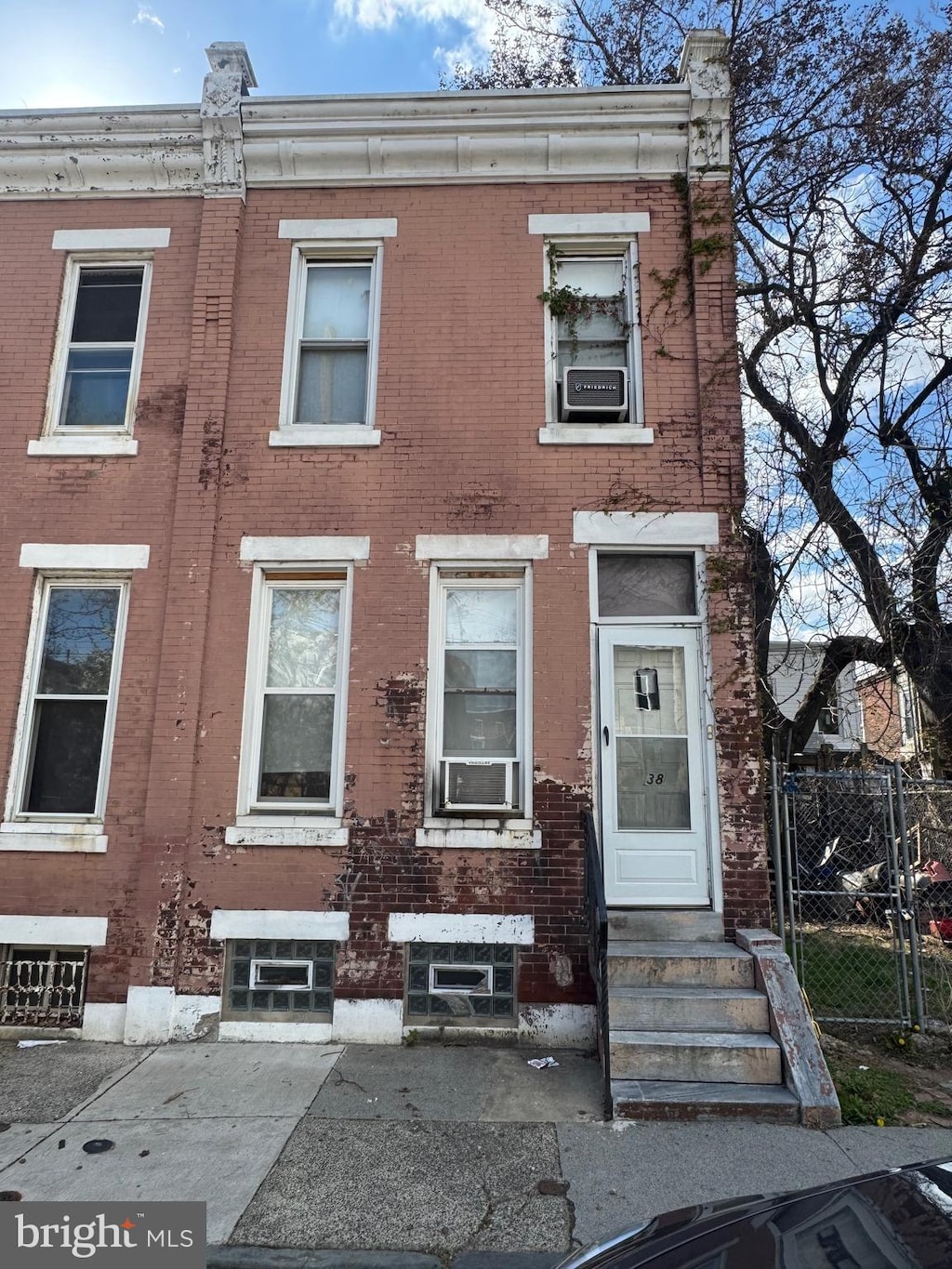2838 N Darien St, Philadelphia, PA 19133 - view of property featuring entry steps, fence, and brick siding
