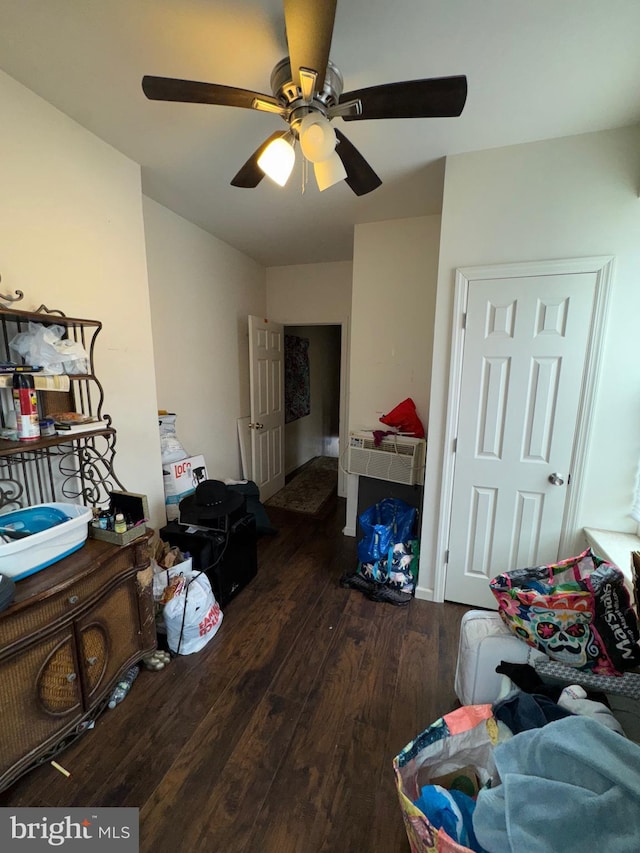 living area with a ceiling fan and hardwood / wood-style flooring