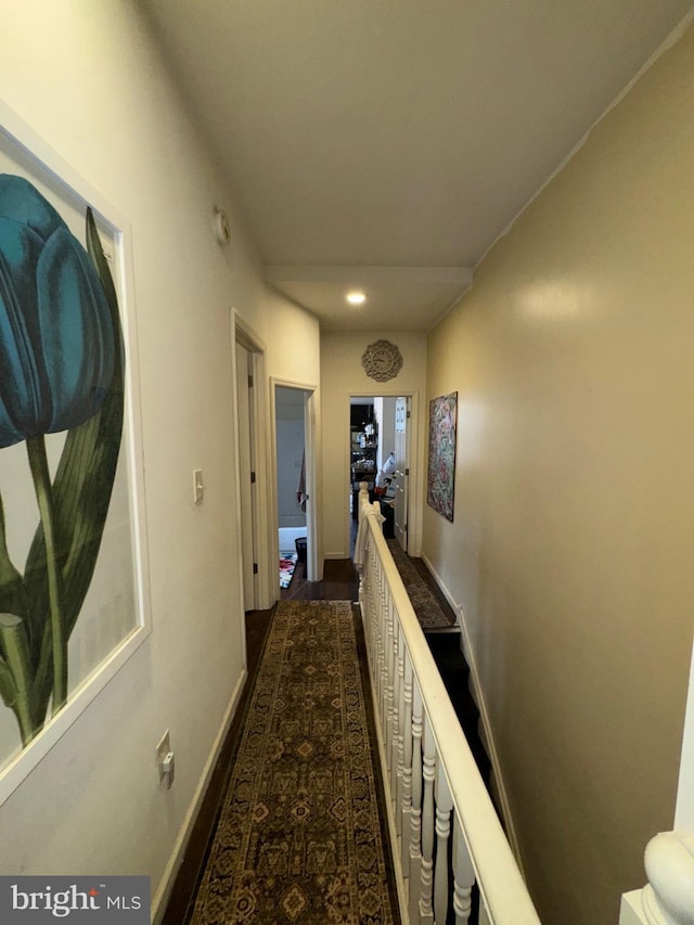 hall with baseboards, recessed lighting, and an upstairs landing