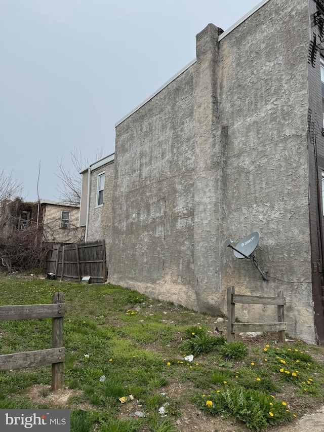 view of home's exterior with fence