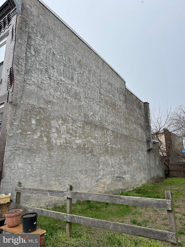 view of home's exterior with fence