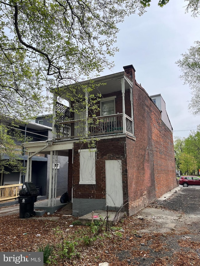 2210 N 6th St, Harrisburg, PA 17110 - rear view of property featuring a chimney, brick siding, and a balcony