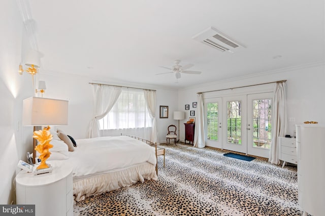 bedroom featuring crown molding, access to exterior, and multiple windows