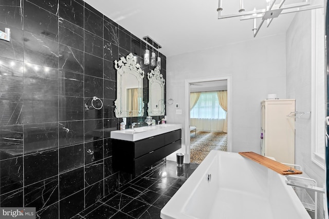 full bathroom featuring vanity, tile walls, and a soaking tub