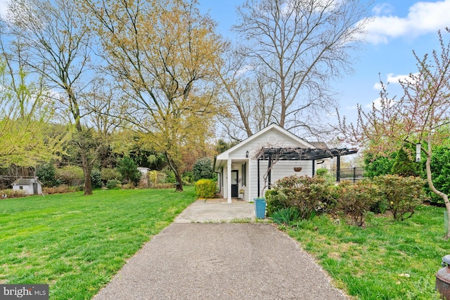 view of home's community with a yard and a pergola
