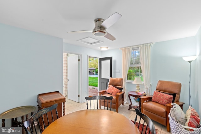 sitting room with light tile patterned floors, attic access, and ceiling fan