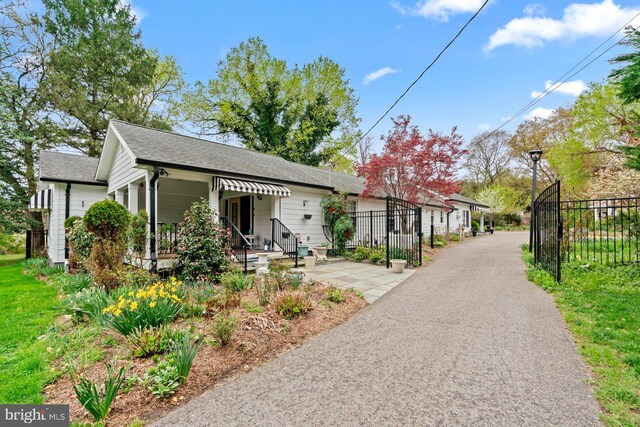 exterior space featuring a shingled roof and fence