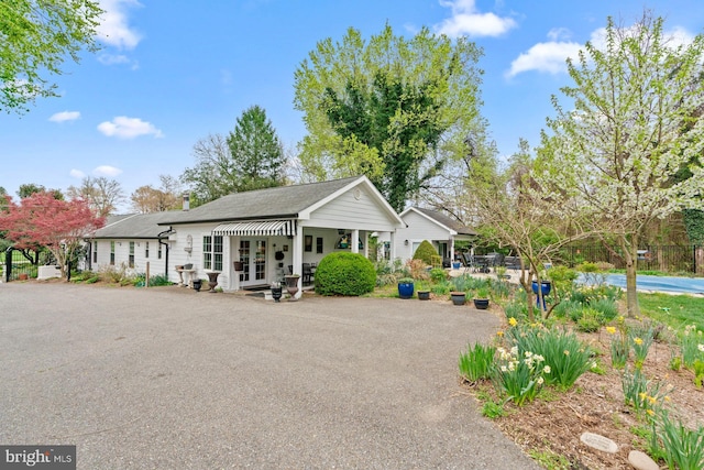 exterior space with french doors and aphalt driveway