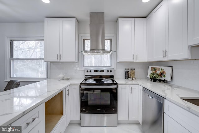 kitchen featuring light stone counters, island exhaust hood, white cabinetry, and stainless steel appliances