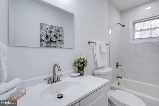 bathroom featuring toilet, vanity, and  shower combination