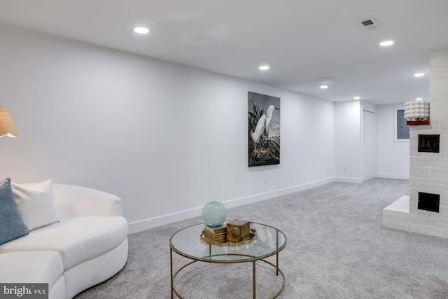 living room featuring carpet floors, recessed lighting, and a fireplace