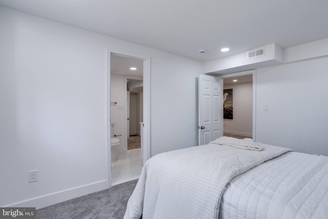 carpeted bedroom featuring visible vents, baseboards, recessed lighting, and ensuite bath