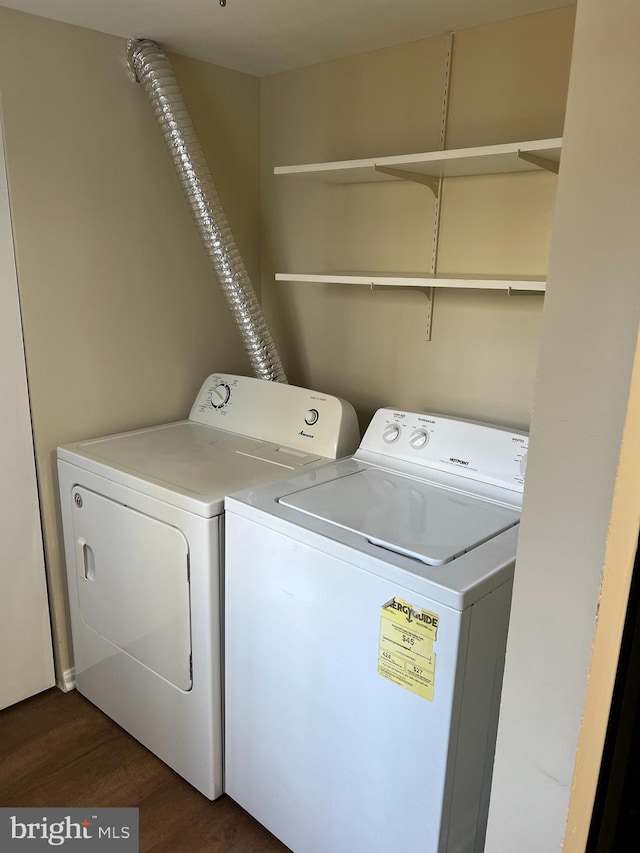 laundry room featuring laundry area, washing machine and clothes dryer, and dark wood-style floors