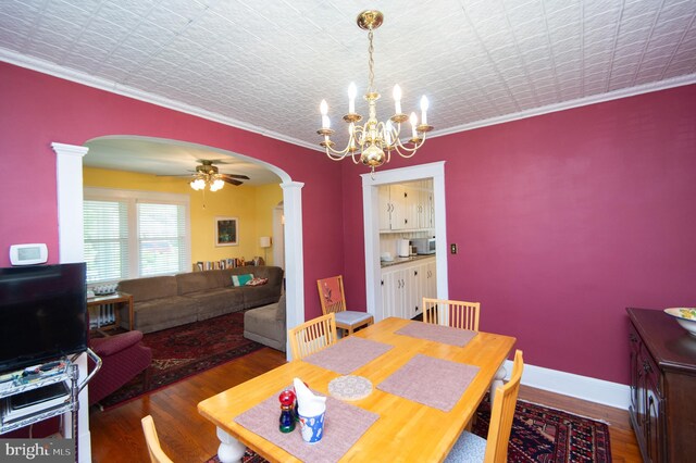 111 Somerset Ave, Cambridge, MD 21613 - dining space with crown molding, arched walkways, ornate columns, and wood finished floors