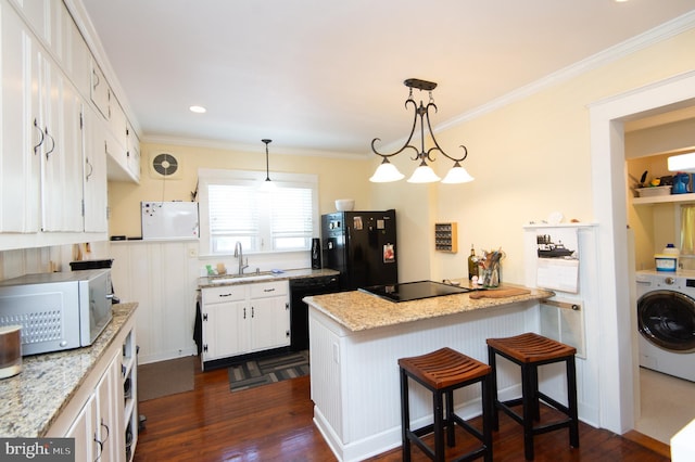 111 Somerset Ave, Cambridge, MD 21613 - kitchen with washer / clothes dryer, dark wood-style floors, white cabinets, a sink, and black appliances