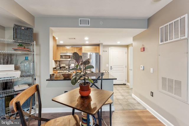 dining space with baseboards, a heating unit, and visible vents