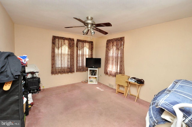 interior space featuring carpet, visible vents, and ceiling fan