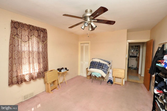 sitting room with visible vents, ceiling fan, and carpet floors