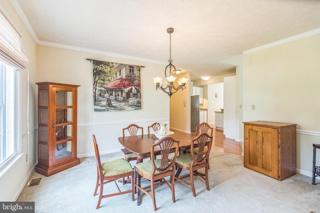 8900 Leonardo St, Pomfret, MD 20675 - dining room with a chandelier, crown molding, light colored carpet, and baseboards