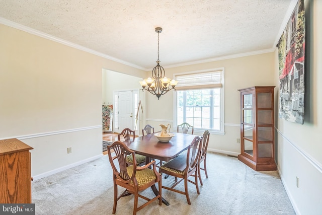 8900 Leonardo St, Pomfret, MD 20675 - dining space with a textured ceiling, light carpet, a chandelier, ornamental molding, and baseboards