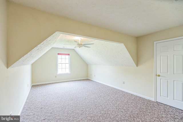 8900 Leonardo St, Pomfret, MD 20675 - bonus room with carpet, baseboards, vaulted ceiling, a ceiling fan, and a textured ceiling