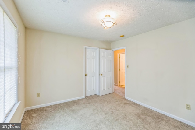 8900 Leonardo St, Pomfret, MD 20675 - unfurnished bedroom with carpet, baseboards, and a textured ceiling