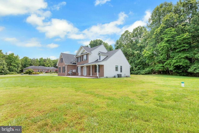 8900 Leonardo St, Pomfret, MD 20675 - back of property with a lawn, brick siding, and cooling unit
