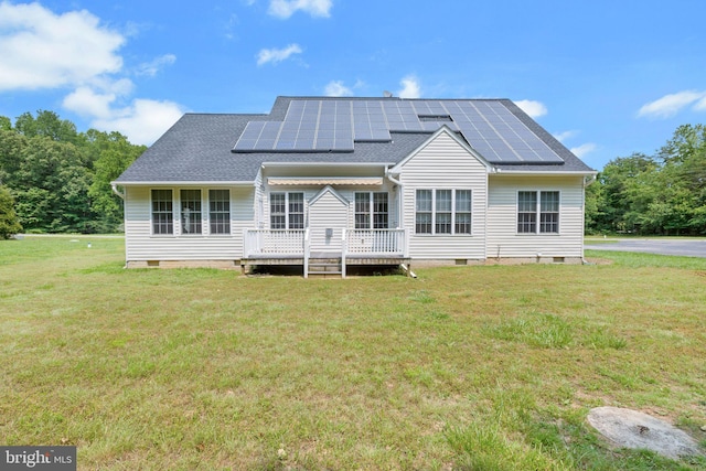 8900 Leonardo St, Pomfret, MD 20675 - back of house with crawl space, a lawn, a deck, and roof mounted solar panels