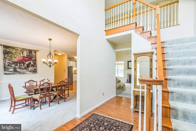 8900 Leonardo St, Pomfret, MD 20675 - entrance foyer featuring stairs, wood finished floors, a chandelier, baseboards, and a towering ceiling