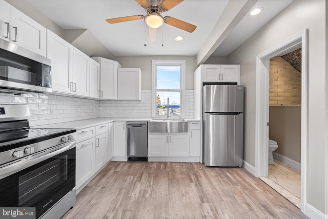 kitchen with white cabinetry, light countertops, ceiling fan, and appliances with stainless steel finishes