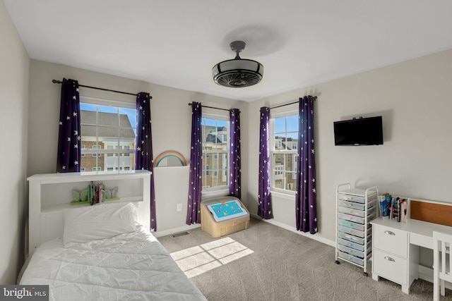carpeted bedroom with visible vents and baseboards