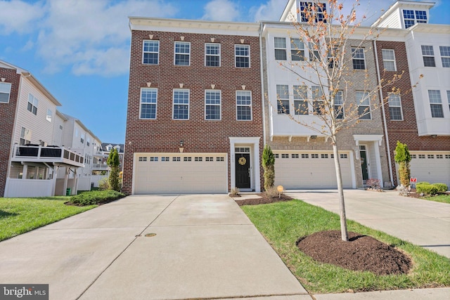 view of front of home with a garage, driveway, and brick siding