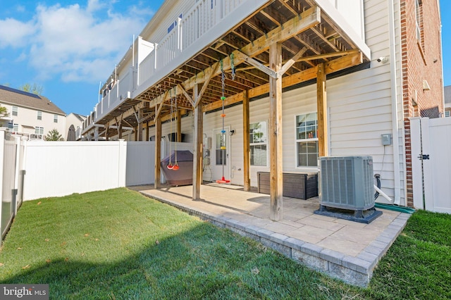 back of house with a patio, a fenced backyard, cooling unit, and a lawn