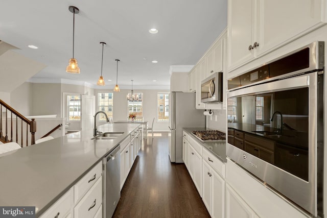 kitchen featuring a healthy amount of sunlight, recessed lighting, a sink, and appliances with stainless steel finishes