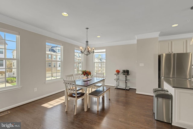 dining area featuring visible vents, baseboards, a notable chandelier, ornamental molding, and dark wood finished floors