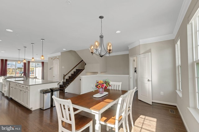 dining area with recessed lighting, dark wood-type flooring, crown molding, stairs, and a notable chandelier
