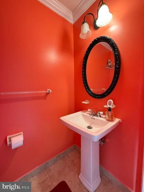 8659 Point Of Woods Dr, Manassas, VA 20110 - bathroom with crown molding, tile patterned floors, and baseboards